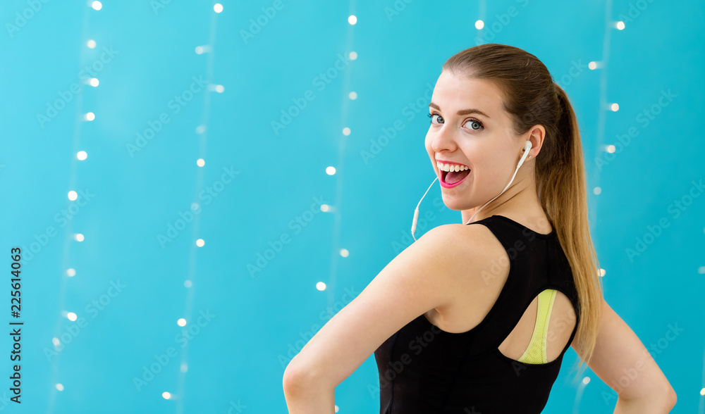 Happy healthy fit woman on a shiny light background