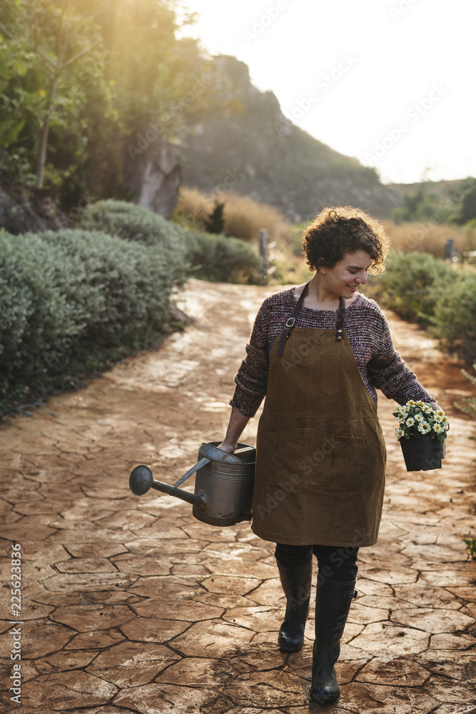 Woman taking care of the flowers at her countryside home