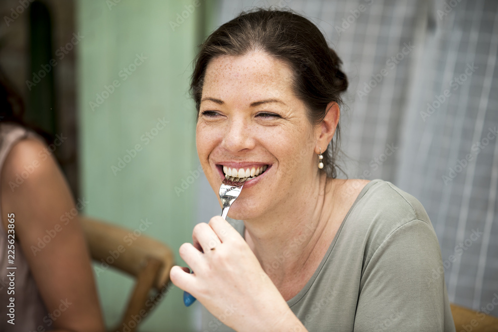 Happy woman having dinner with friends