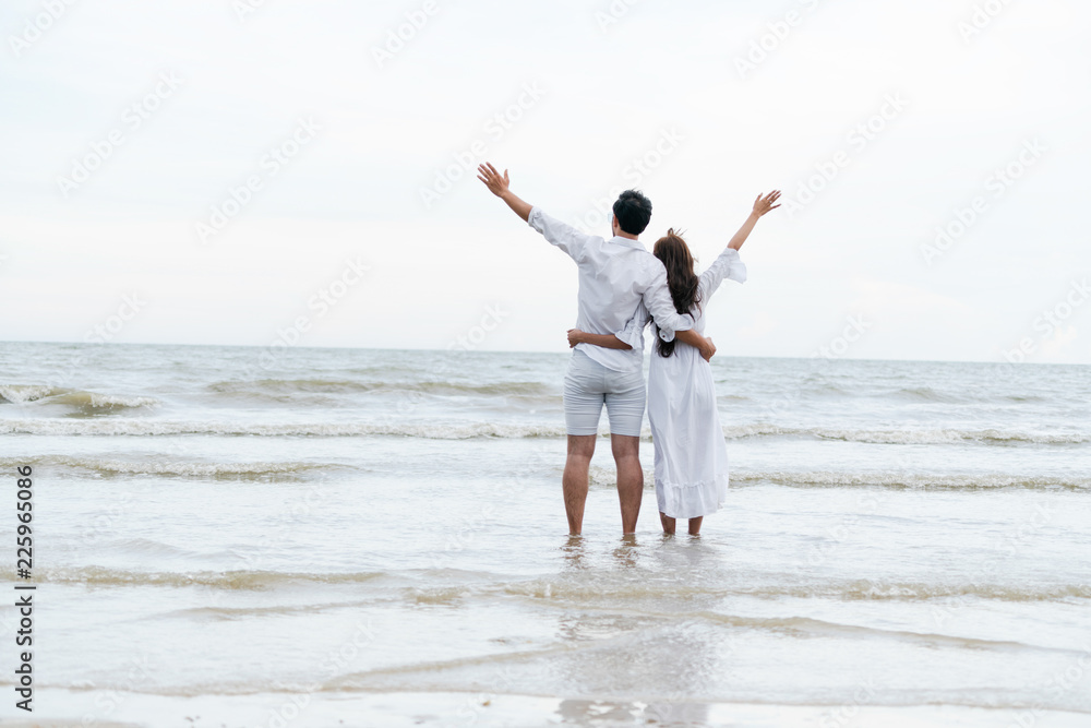 Couple going honeymoon on tropical beach in summer