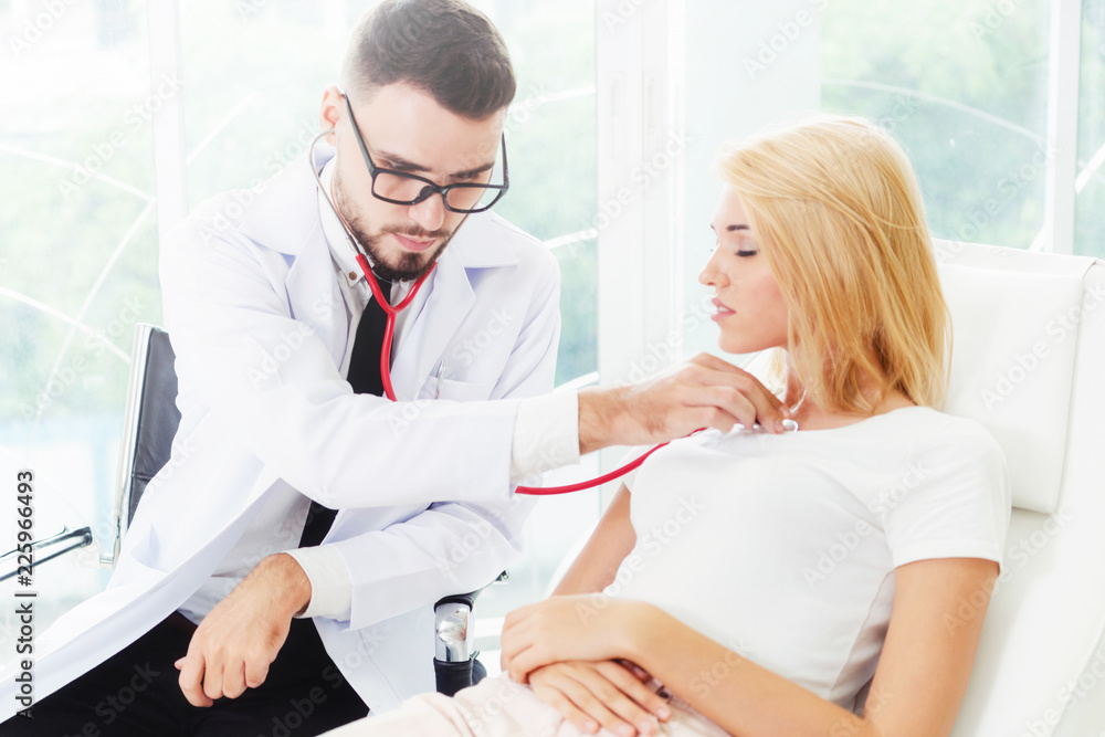 Male Doctor and Female Patient in Hospital Office