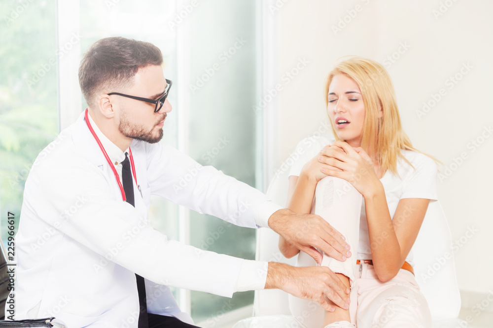 Male Doctor and Female Patient in Hospital.