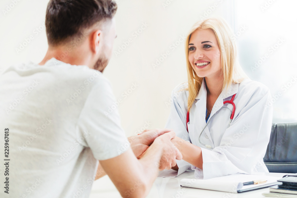 Woman Doctor and Male Patient in Hospital Office