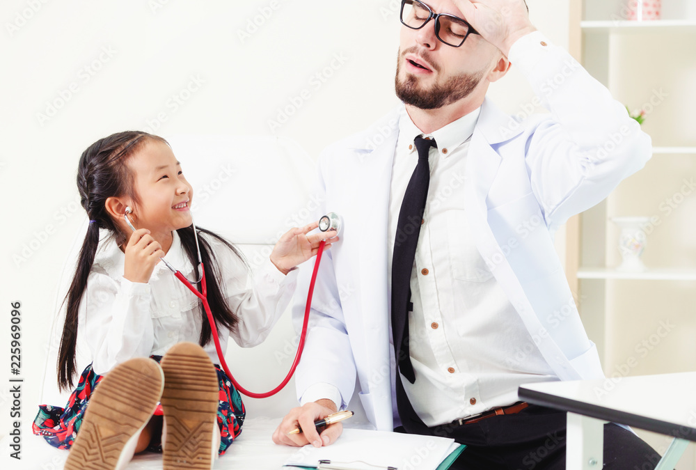 Happy little kid visit doctor in hospital office.