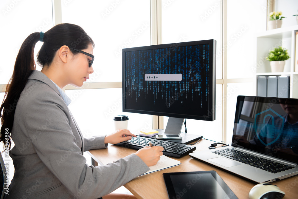 female staff is writing while log in