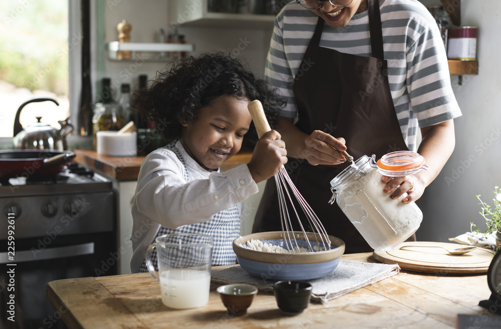 Mother and son cooking in kitchen