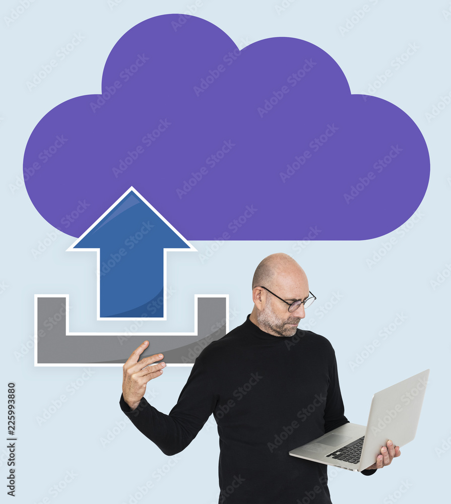 A cheerful man holding a laptop sync to cloud computer