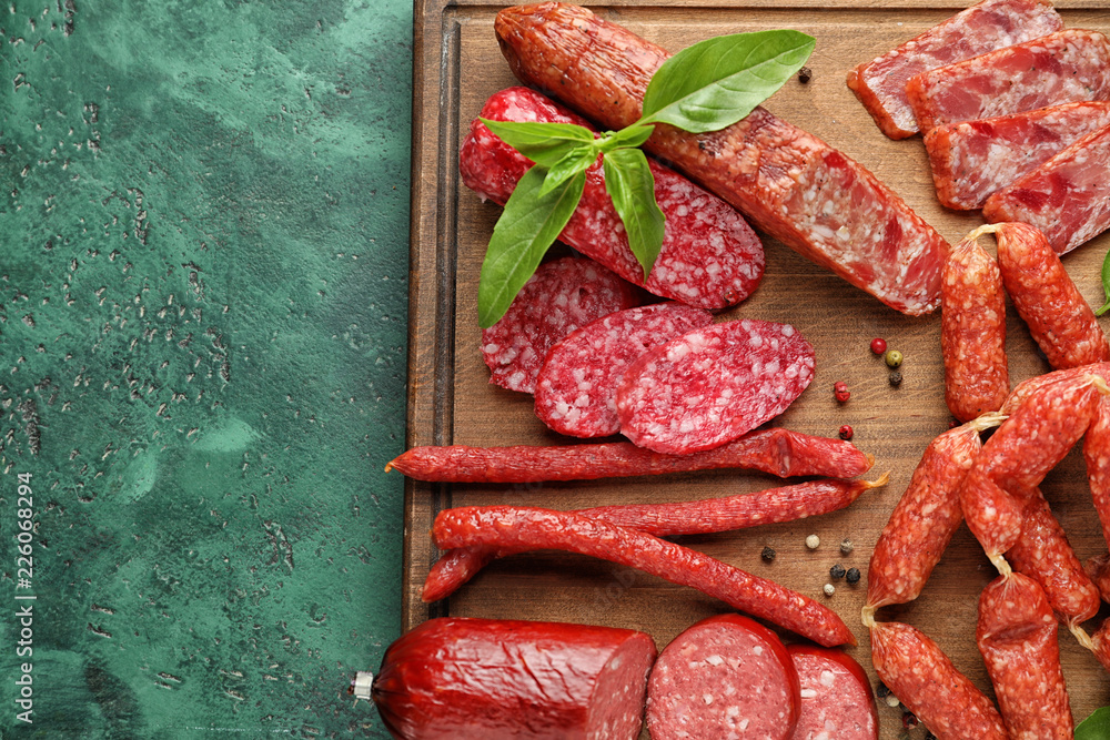 Different kinds of smoked sausages on wooden board