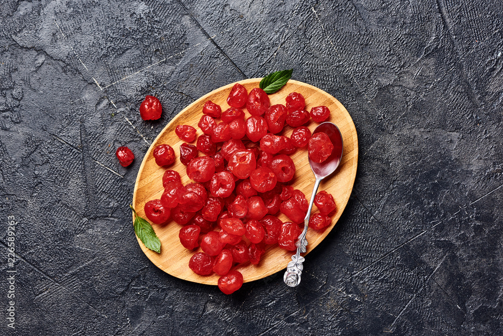 Candied dried cherry on plate. Top view of berries.