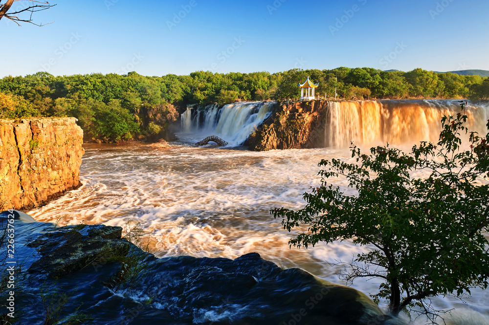 Ching-po Lake waterfalls of China sunset landscape.