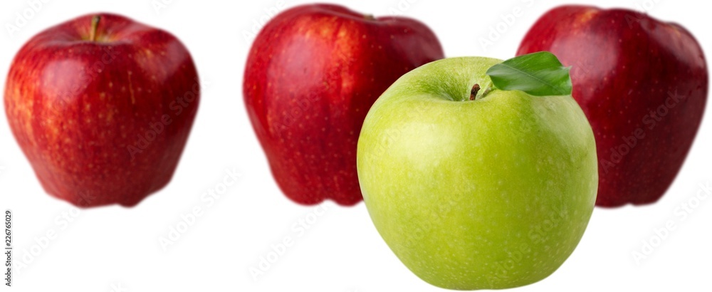 Green Apple in Front of Red Apples