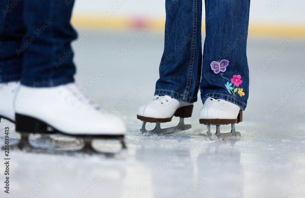 Close-up of Legs in Skates on Skating Rink