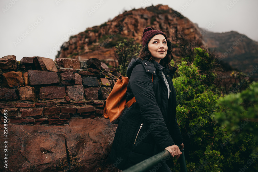 Woman relaxing on vacation at mountain top viewpoint