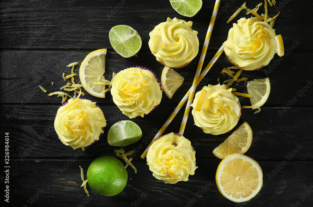 Delicious lemon cupcakes on wooden table, top view