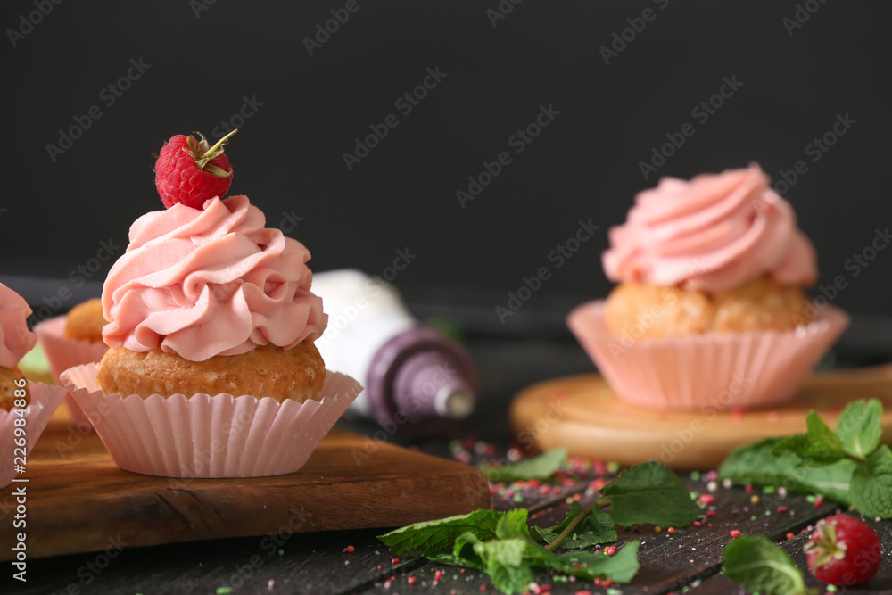 Delicious cupcake on wooden board