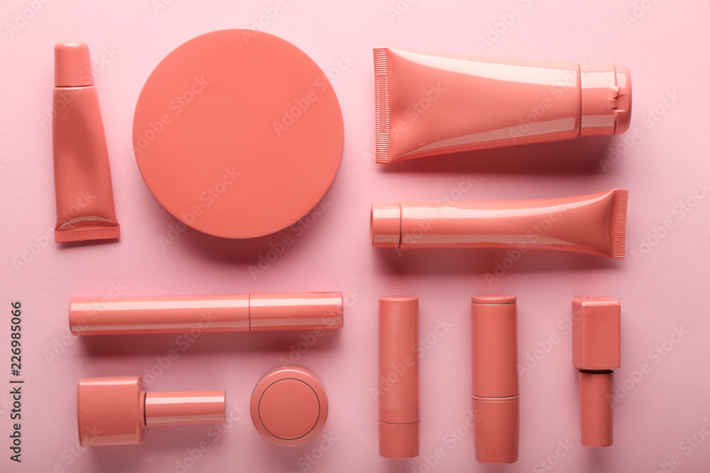 Set of pink decorative cosmetics on color background