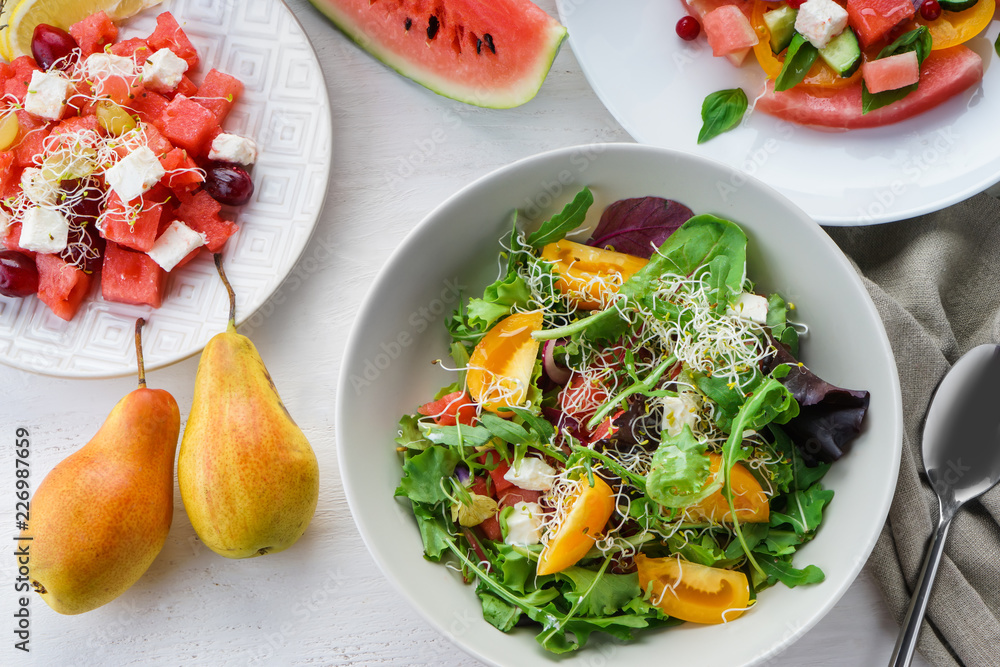 Plates with delicious watermelon salads on white table