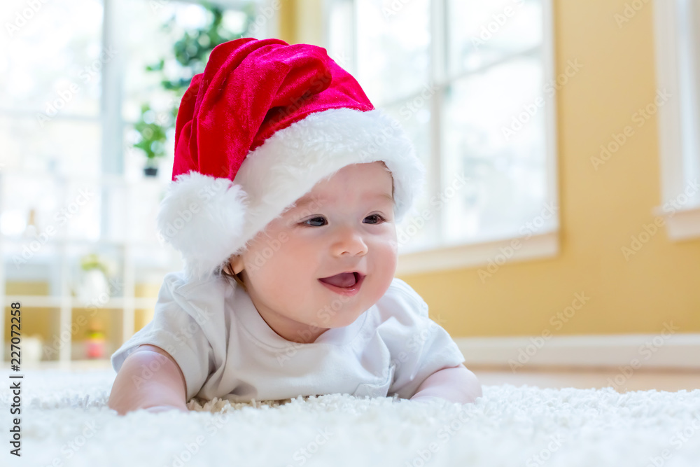 Baby boy with a Santa hat on Christmas morning