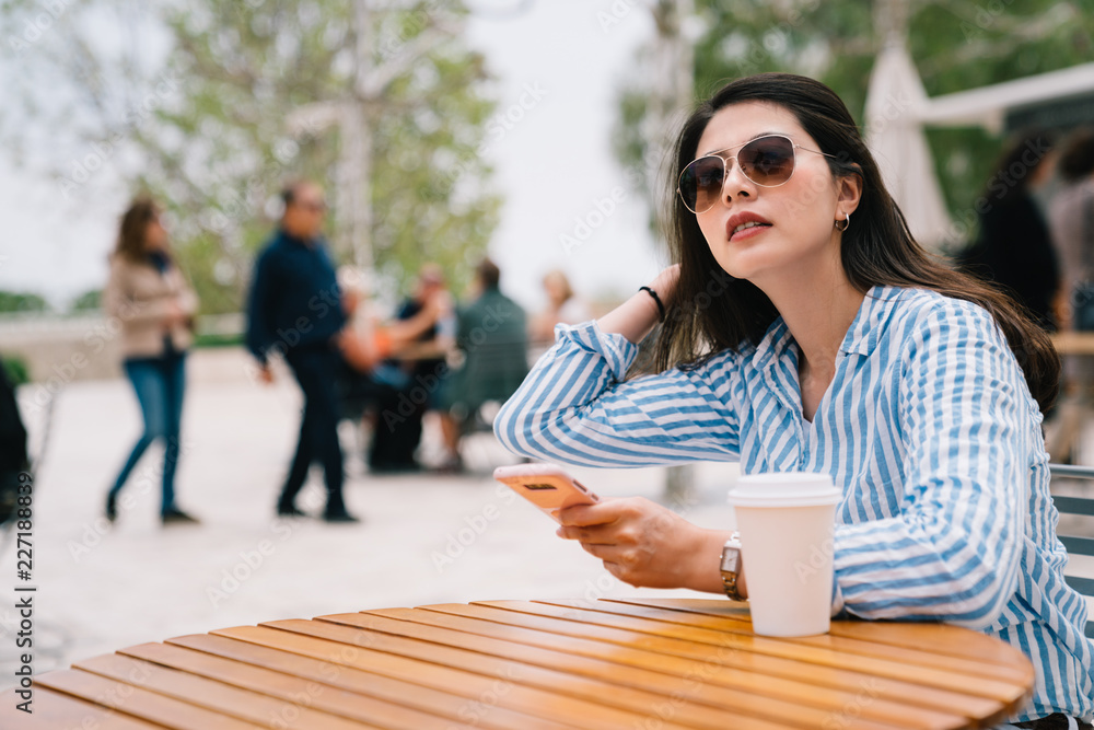 woman wearing sunglasses flicks her hair