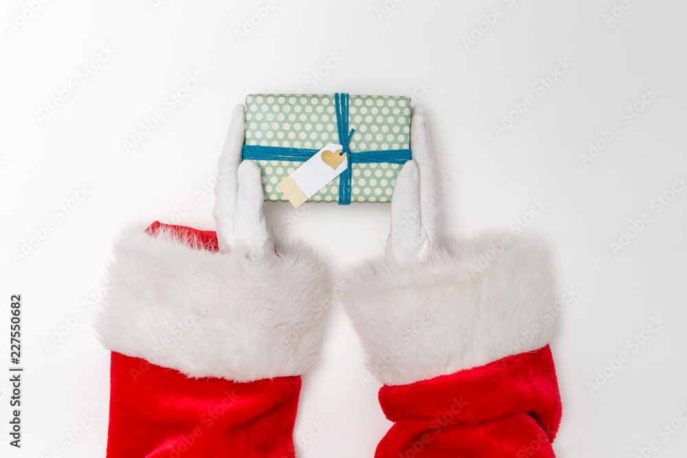 Santa holding a Christmas gift on a white background