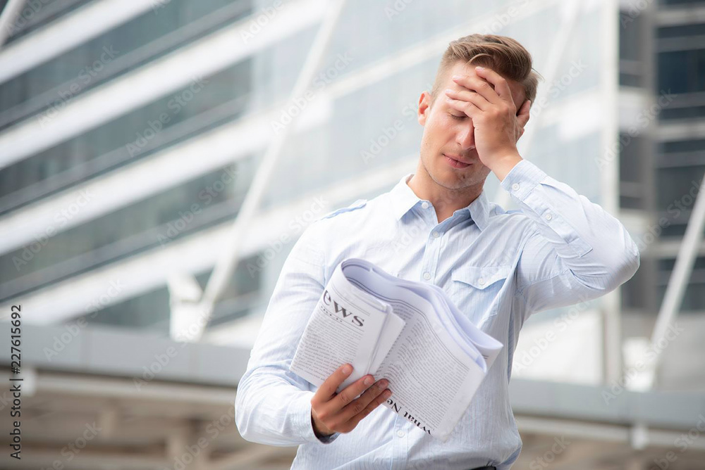 Business people reading newspaper outdoor