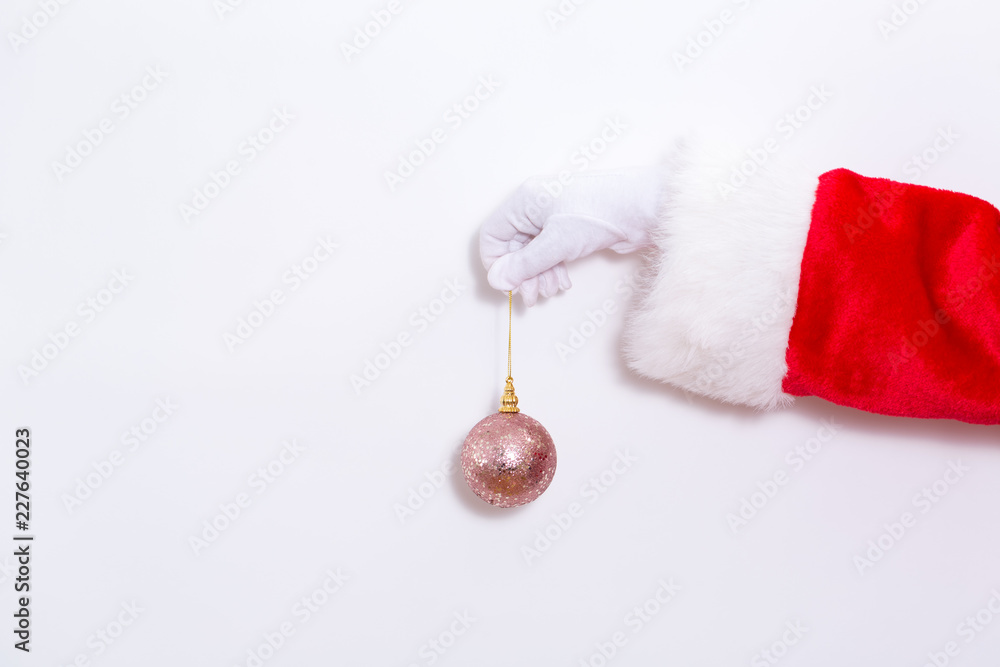 Santa claus holding a pink bauble on a white background