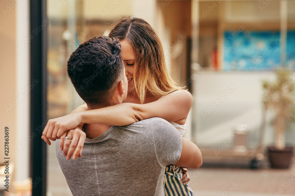 Affectionate young couple sharing a kiss in the city