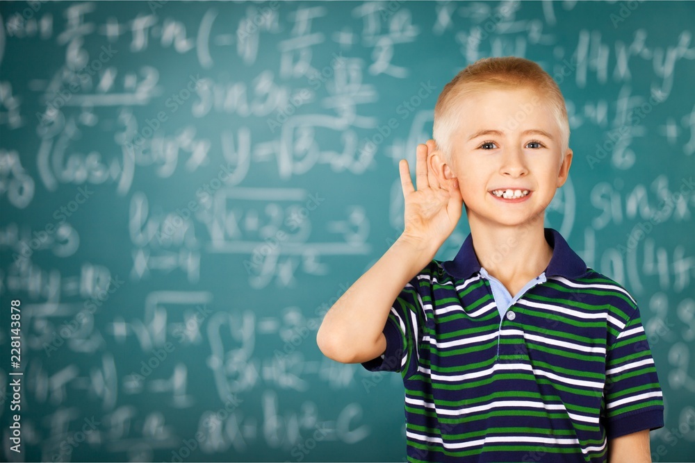 Little boy listening in the classroom