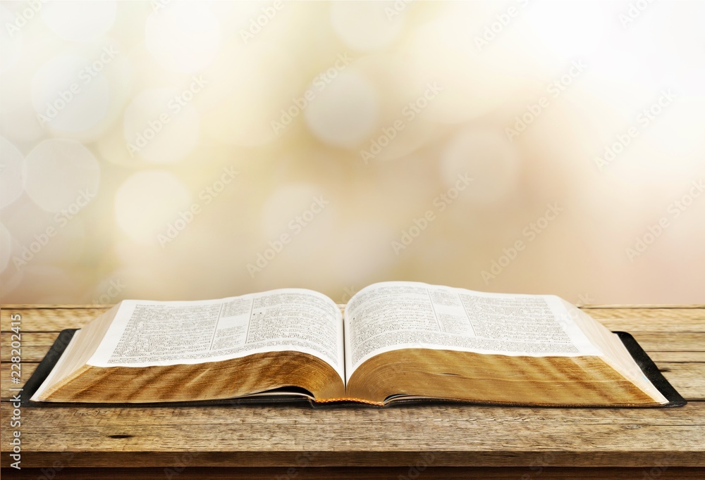 Open book on old wooden table