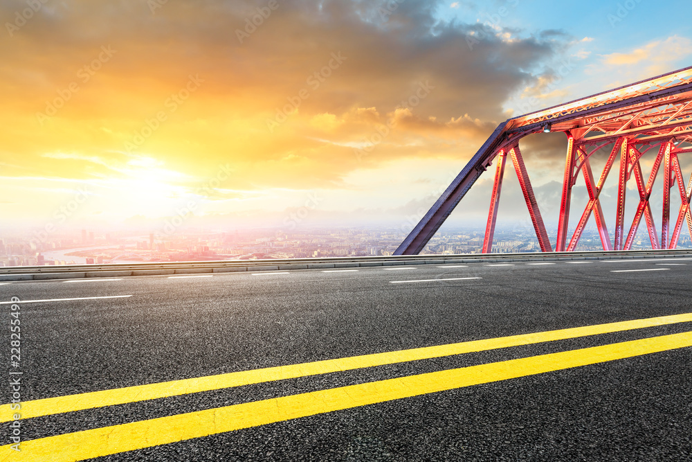 Empty asphalt road and modern city landmark building with steel bridge in shanghai