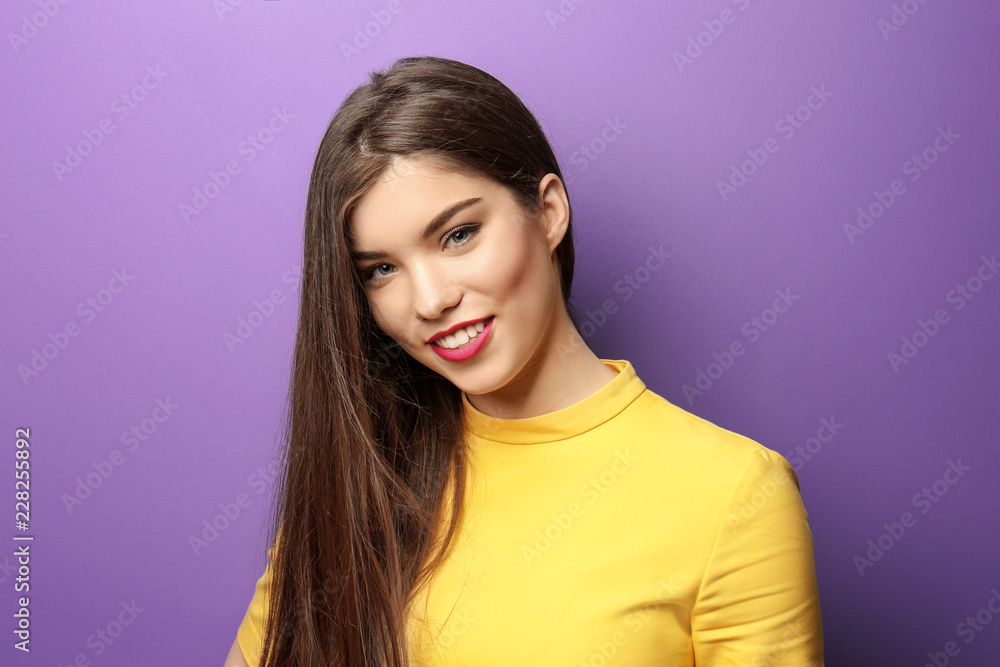 Young woman with beautiful hair on color background