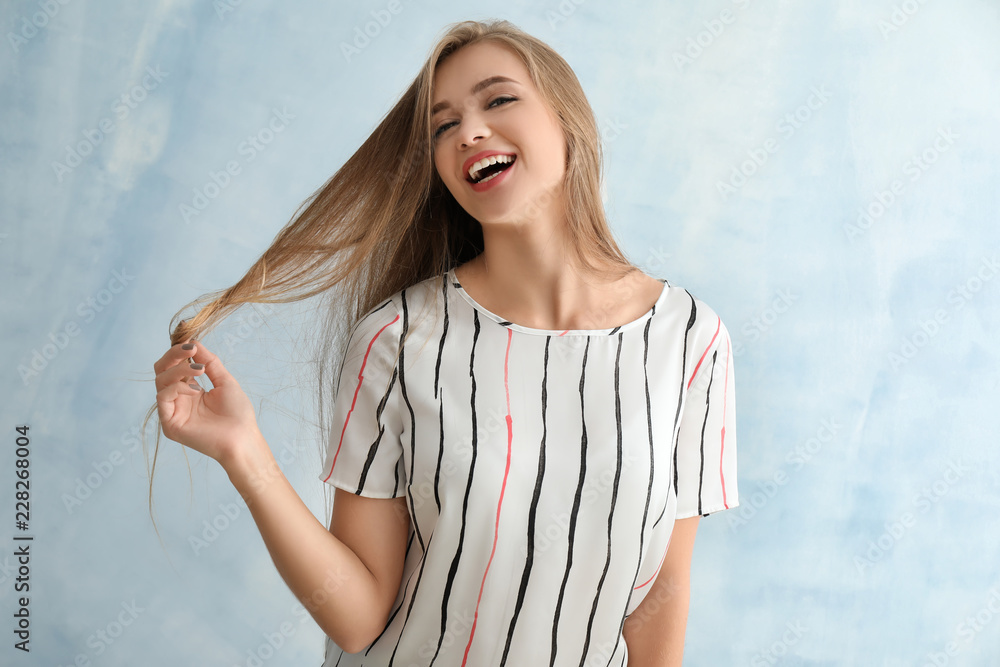 Portrait of happy beautiful young woman on color background