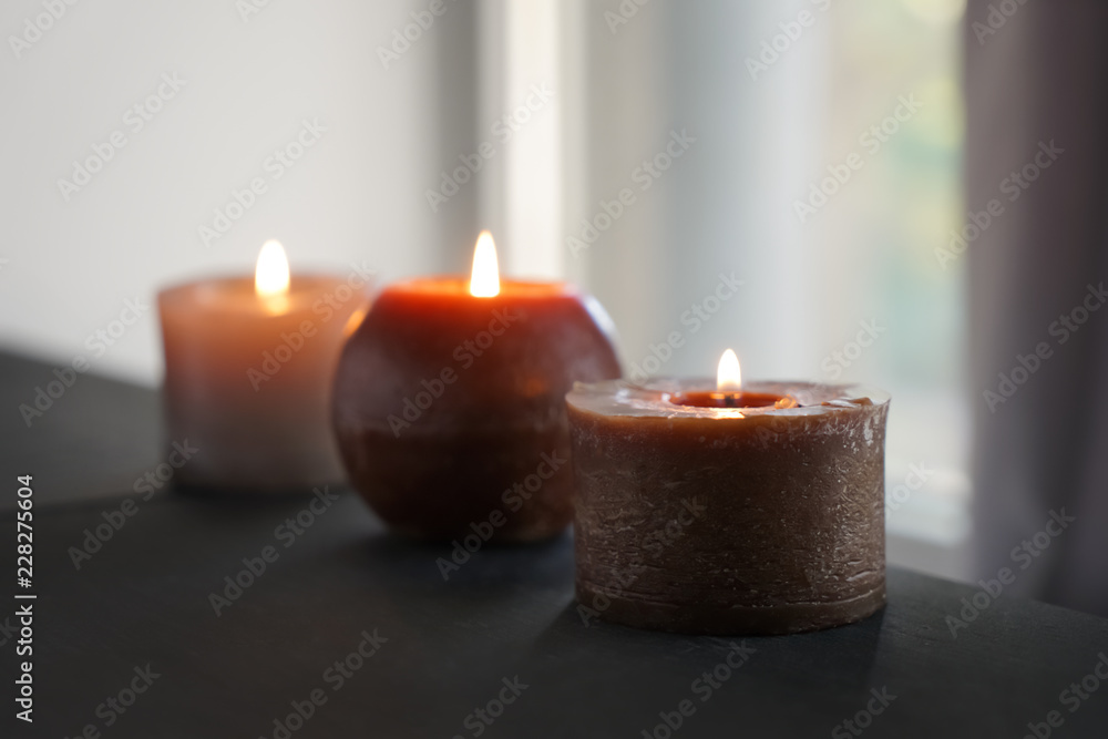 Beautiful burning candles on dark table