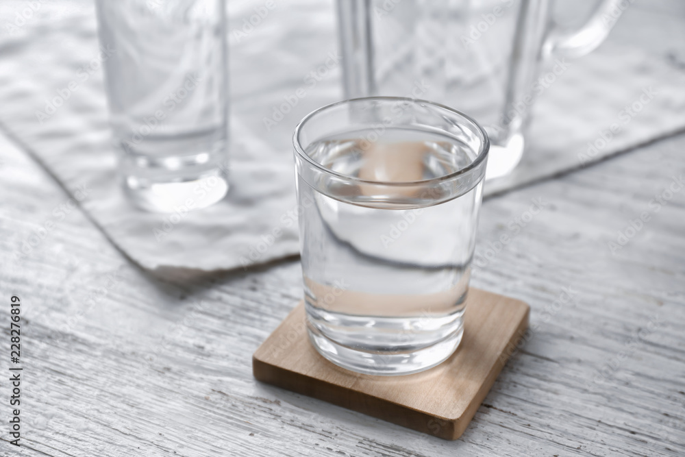 Glass of fresh water on wooden table