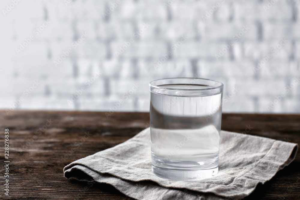 Glass of tasty clean water on table