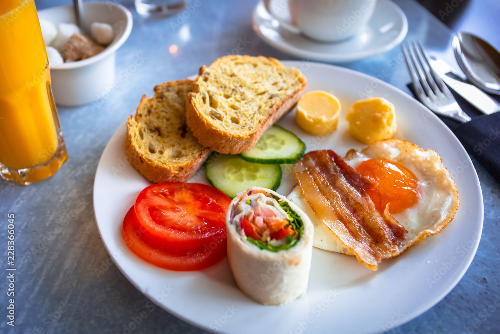 Plate with continental breakfast on the table