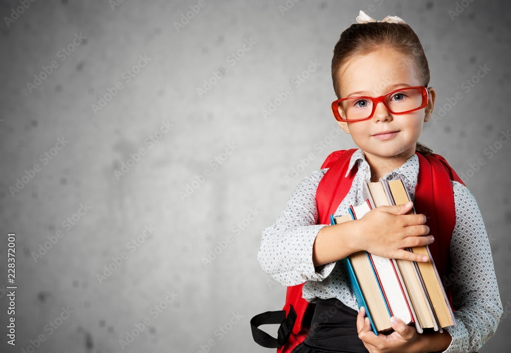 Portrait of young cute girl with books