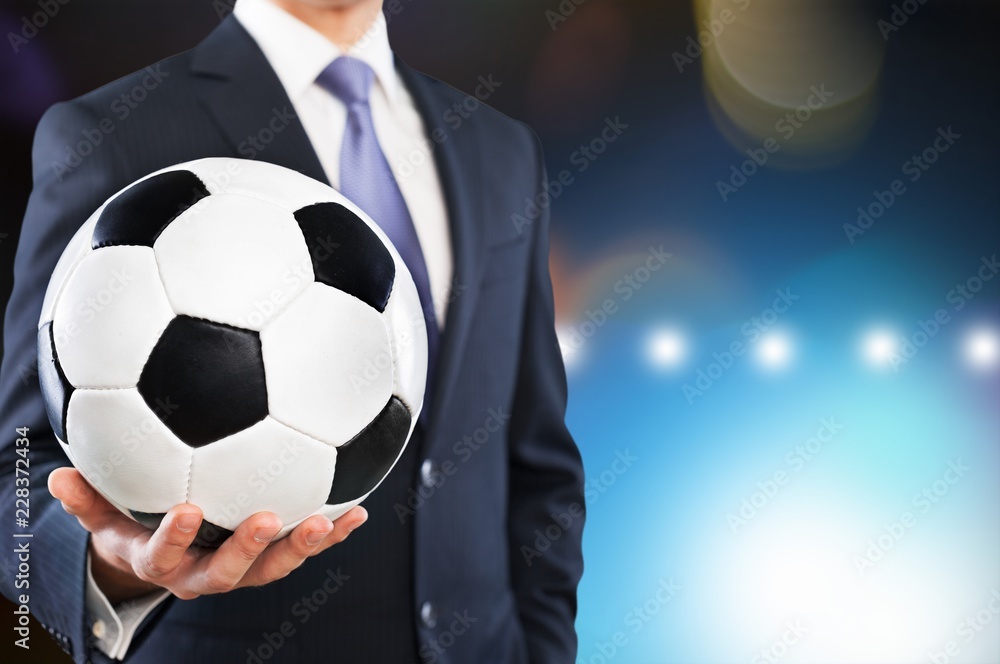 Close-up young male businessman holding Soccer ball