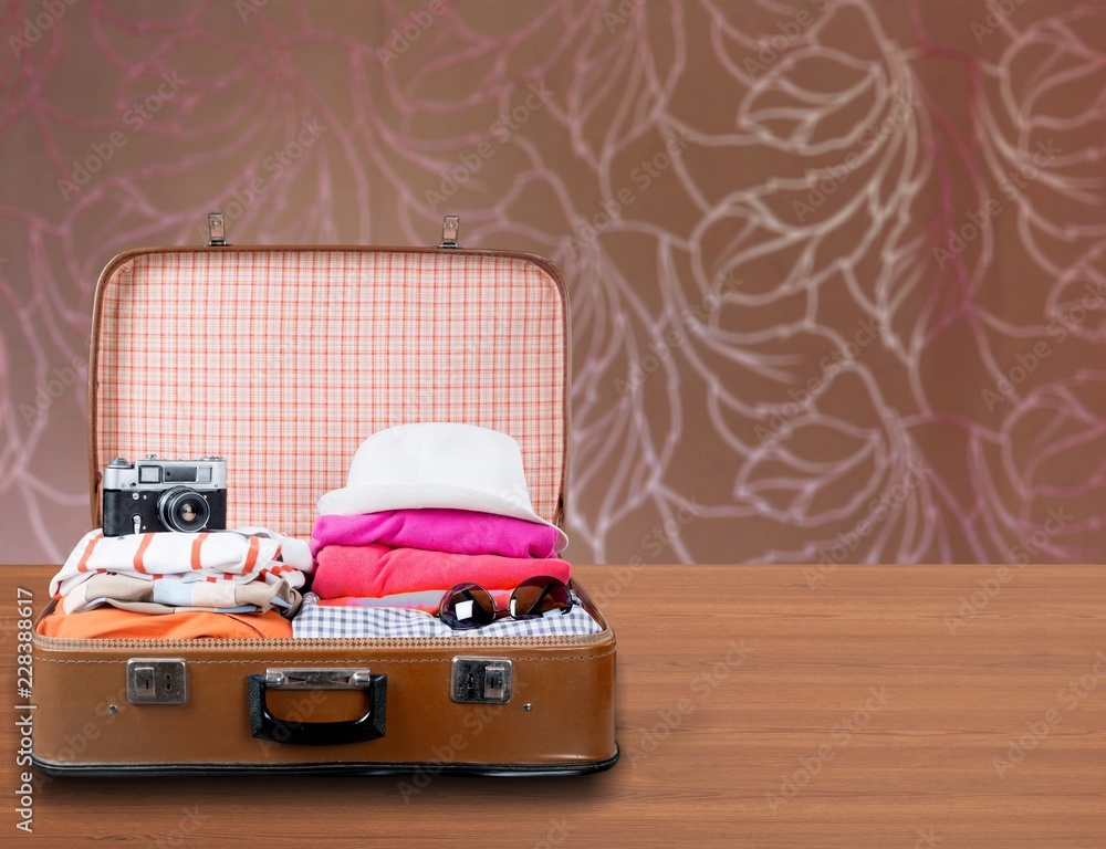 Travel bag on wooden floor and blue wall background