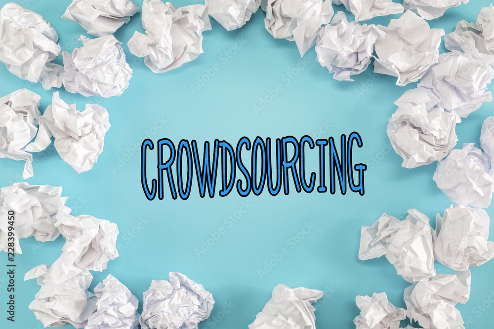 Crowdsourcing text with crumpled paper balls on a blue background