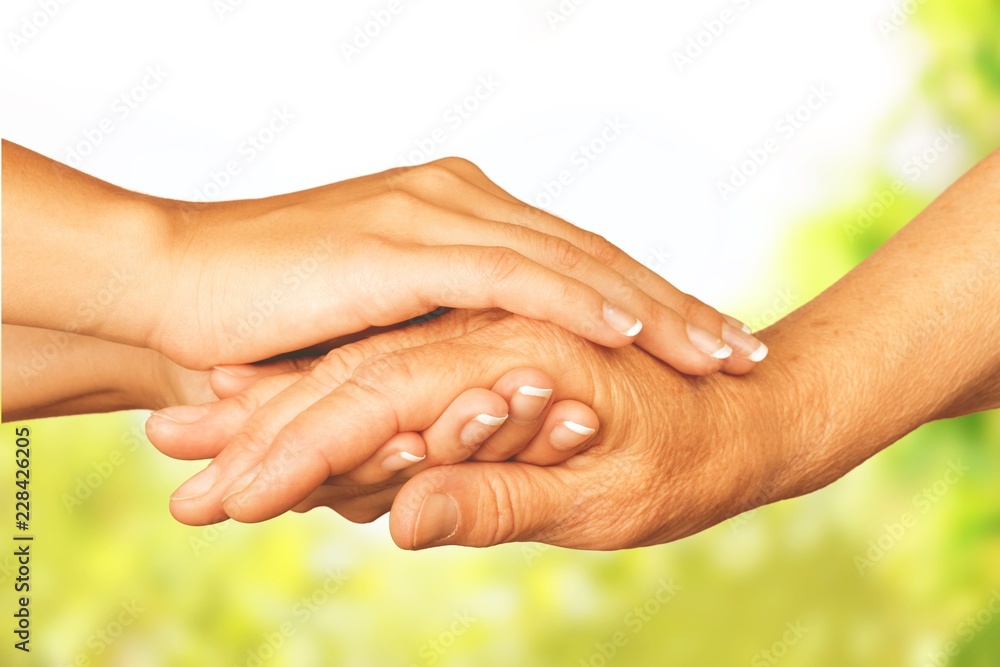 Old and young hands, close-up view