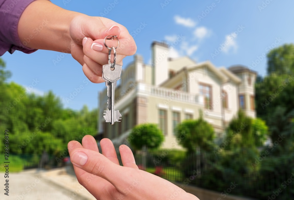 Real estate agent giving Key to client,