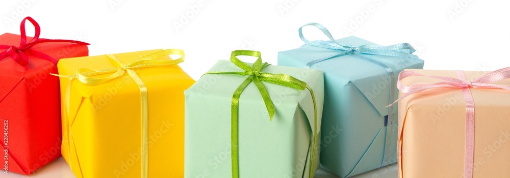 Small boxes wrapped in solid colored wrapping paper with