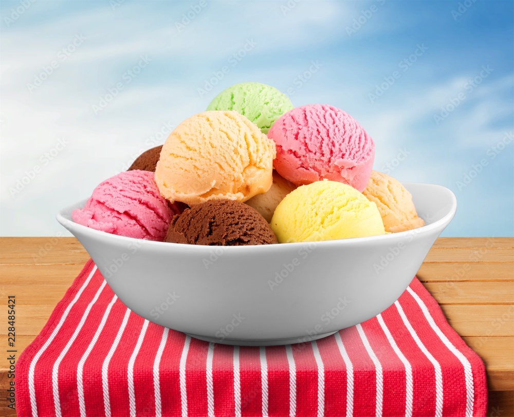 Ice cream scoops in bowl on plate