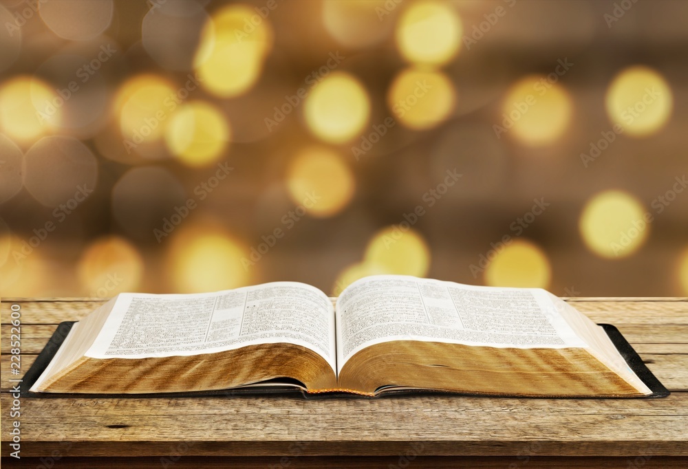 Open book on old wooden table