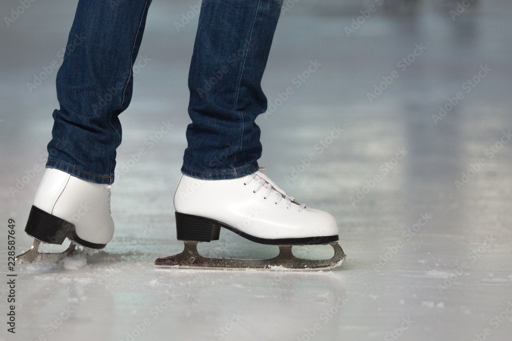 Close-up of Legs in Skates on Skating Rink