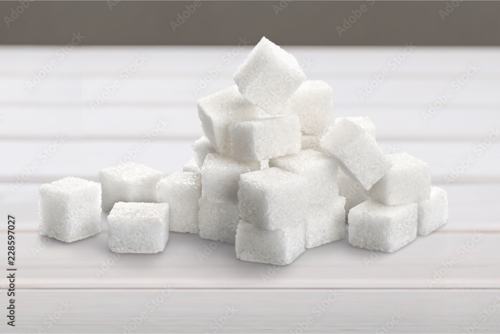 Cubes of sugar on white background