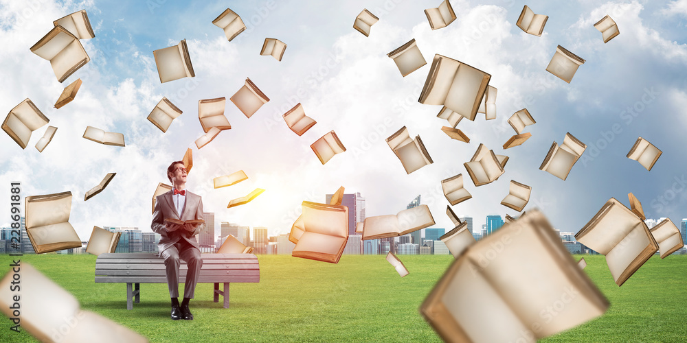 Young businessman or student studying the science in summer park