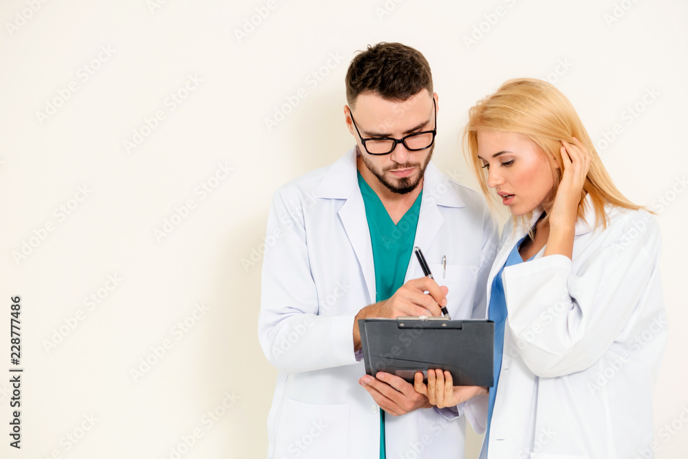 Doctors looking and discussing on documents paper.