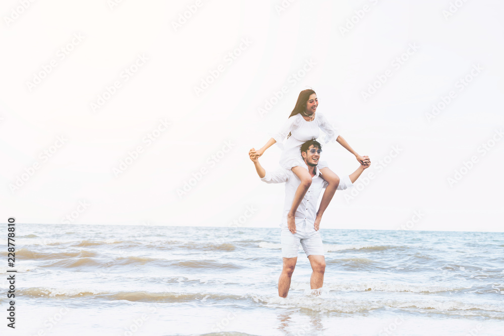 Couple going honeymoon on tropical beach in summer